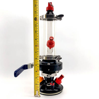 Clear cylindrical device with red and blue components, height measured by a tape measure on a white background