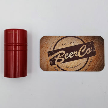 Red cylindrical container next to a wooden coaster with 'BeerCo' branding on a white background