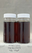 Two glass jars with white lids containing Dark Agave Syrup