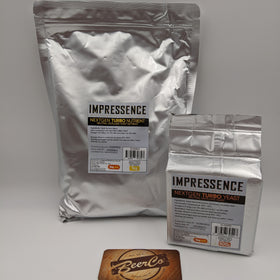 Two silver foil bags of Impressence Next Gen Turbo Yeast, one large 1kg bag and one smaller 500g bag, displayed on a light gray background with a BeerCo coaster in the foreground.