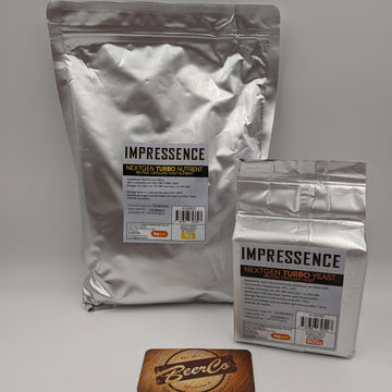 Two silver foil bags of Impressence Next Gen Turbo Yeast, one large 1kg bag and one smaller 500g bag, displayed on a light gray background with a BeerCo coaster in the foreground.