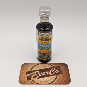 Bottle of Still Spirits Pineapple Rum Flavouring with a matching coaster featuring BeerCo branding on a white background.