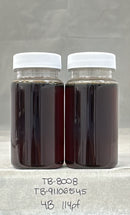 Two glass jars with white lids containing a dark liquid on a gray background.