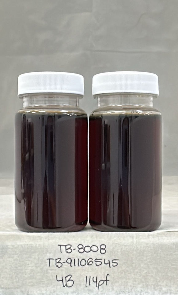 Two glass jars with white lids containing a dark liquid on a gray background.