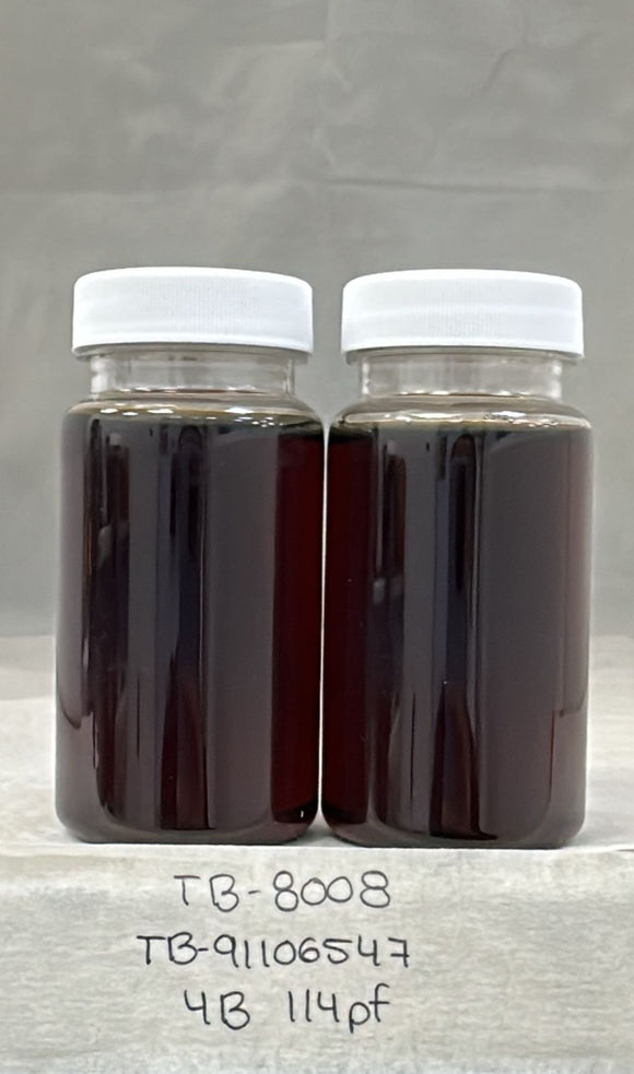 Two jars of dark liquid with white lids on a gray background