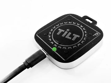 Black and white device with 'TILT' branding on a white background